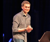 a man standing in front of a microphone